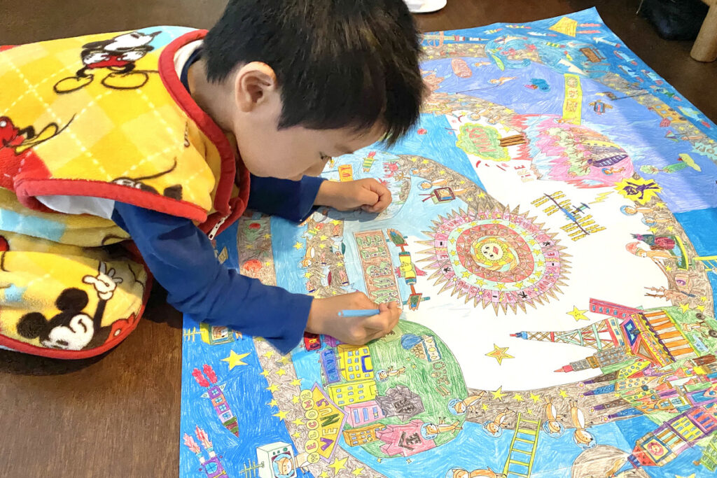 ぬりえに集中する幼いAKASHI。色を丁寧に塗る様子